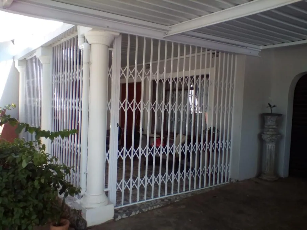 White aluminium trellis security gates closing off a covered patio